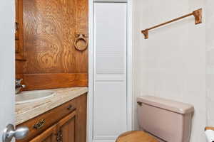 Half bathroom with toilet and vanity