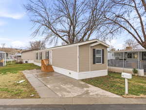 Manufactured / mobile home featuring a front lawn and crawl space