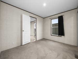Unfurnished room with light carpet and ornamental molding