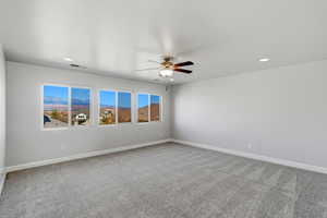 Unfurnished room with light carpet, a ceiling fan, and recessed lighting