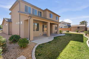 Back of property featuring a patio, stucco siding, and an outdoor structure
