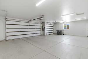 Garage with baseboards and a garage door opener