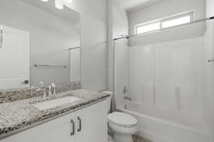 Bathroom with vanity and shower / tub combination