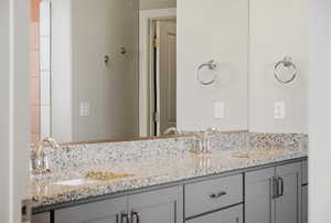 Full bath featuring double vanity