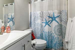 Full bathroom featuring vanity and toilet