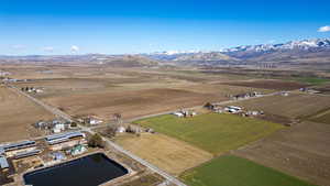 Aerial view of property and surrounding area with rural landscape and a mountain backdrop