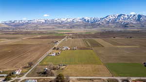 View of property location featuring a mountain backdrop, rural landscape, and abundant farmland