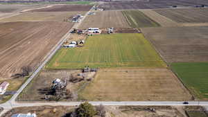 Aerial view of property's location with rural landscape and rows of crops