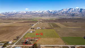Overview of rural landscape with property boundaries highlighted and a mountain backdrop