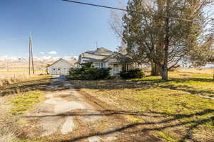 Bungalow-style house featuring a mountain view, a front lawn, and driveway