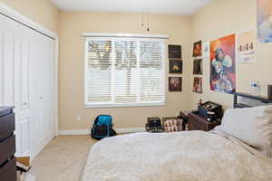 Bedroom with carpet and a closet