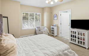 Bedroom featuring light colored carpet and a ceiling fan
