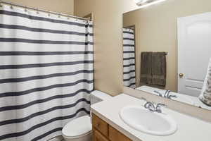 Full bathroom featuring vanity and a shower with curtain
