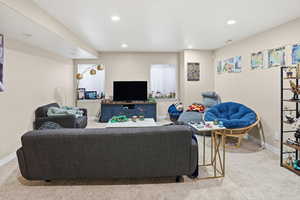 Living room featuring light colored carpet and recessed lighting