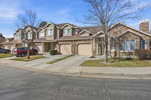 Traditional home with stone siding and driveway