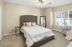 Bedroom featuring light colored carpet and ceiling fan