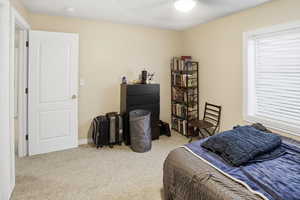 Bedroom with light carpet and ceiling fan