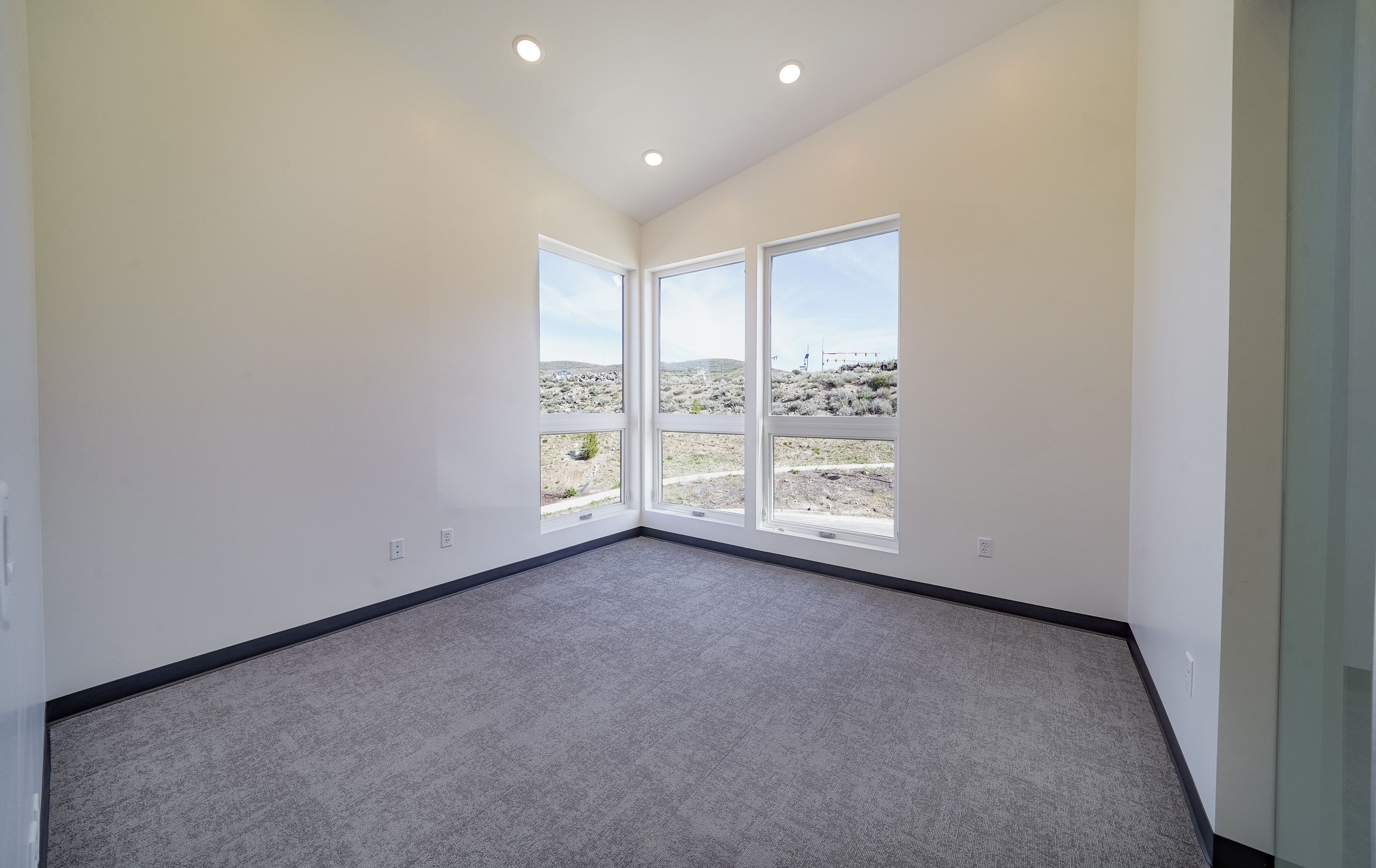 Empty room with carpet, recessed lighting, and lofted ceiling