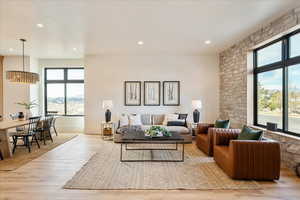 Living area with light wood finished floors and recessed lighting