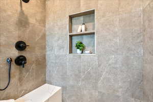 Full bath featuring tiled shower