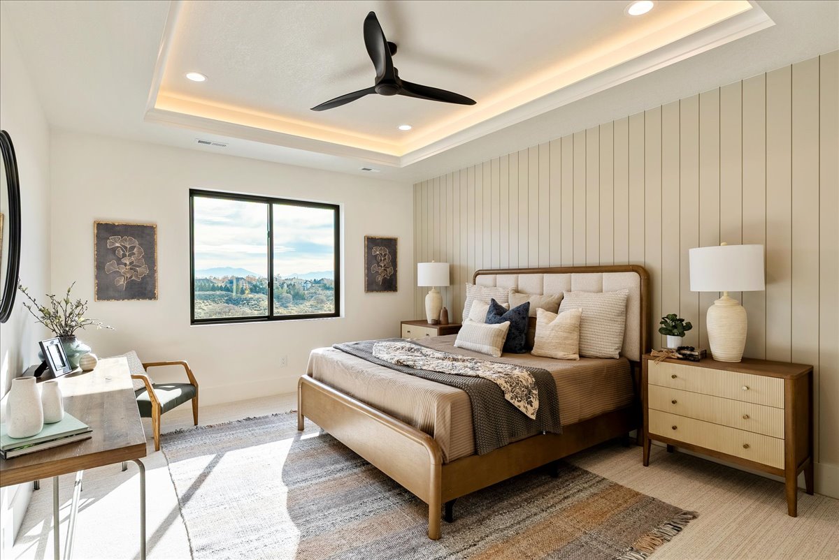 Bedroom featuring a ceiling fan, recessed lighting, and a tray ceiling