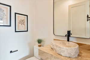 Half bath featuring toilet and vanity