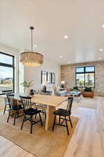 Dining space featuring light wood finished floors, healthy amount of natural light, and recessed lighting