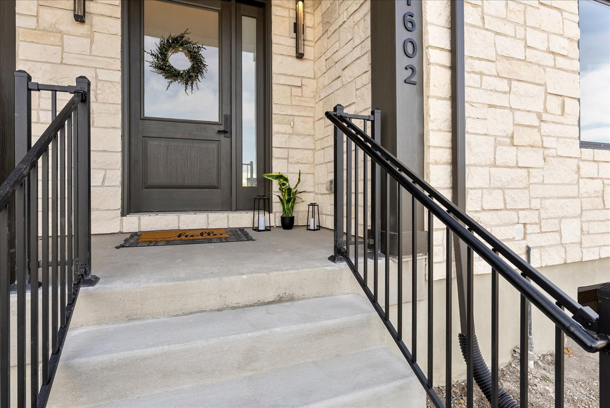 Entrance to property with stone siding