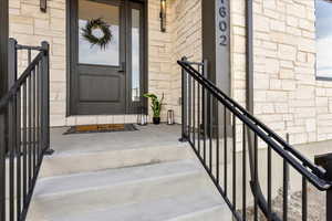 Entrance to property with stone siding