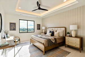 Bedroom featuring a ceiling fan, recessed lighting, and a tray ceiling