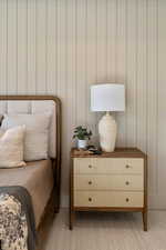 Bedroom featuring light carpet