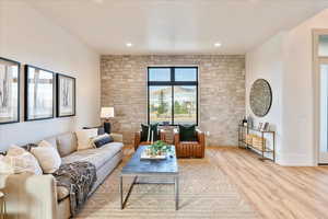 Living room featuring light wood-style flooring and recessed lighting