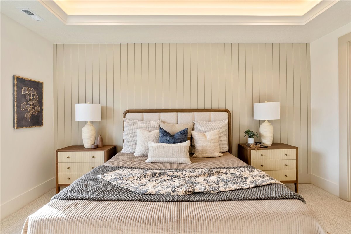Bedroom featuring light carpet and baseboards