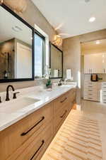Full bath with double vanity, recessed lighting, light tile patterned floors, and a shower