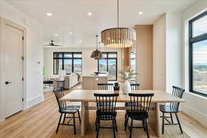 Dining room featuring light wood-style flooring, a ceiling fan, and recessed lighting