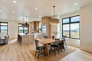 Dining area featuring light wood-style flooring, recessed lighting, and a mountain view