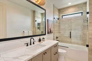 Full bathroom featuring vanity and combined bath / shower with glass door