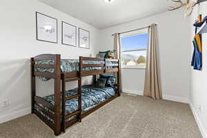 Bedroom featuring baseboards and light colored carpet