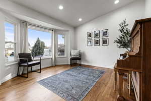 Sitting room featuring lofted ceiling, light wood-type flooring, and recessed lighting