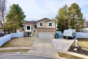 View of front of property with concrete driveway, an attached garage, and brick siding
