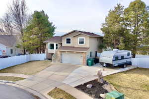View of front of property featuring brick siding, an attached garage, and concrete driveway
