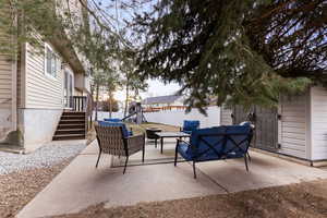 Patio terrace at dusk featuring an outdoor hangout area, a playground, a patio area, and a fenced backyard