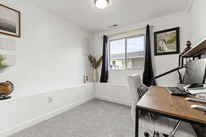 Office space featuring baseboards and light carpet