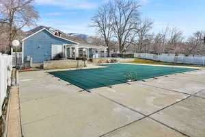 View of pool with patio surround and a mountain view