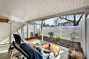 Sunroom / solarium featuring a patio and lofted ceiling