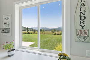 Doorway to outside with healthy amount of natural light, a mountain view, and a view of rural / pastoral area