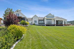 View of front of home featuring french doors, board and batten siding, and a front yard