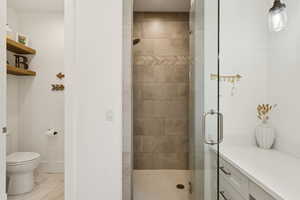 Full bathroom with toilet and a stall shower