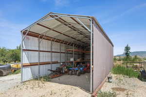 View of pole building with a carport