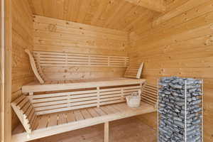 Relaxing sauna / steam room featuring wooden walls and wooden ceiling